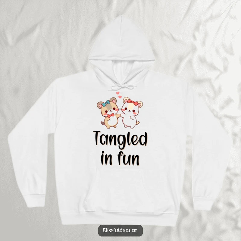 Funny hoodie showing two small, round animals in matching bows joyfully holding hands and spinning, perfect for cold days.